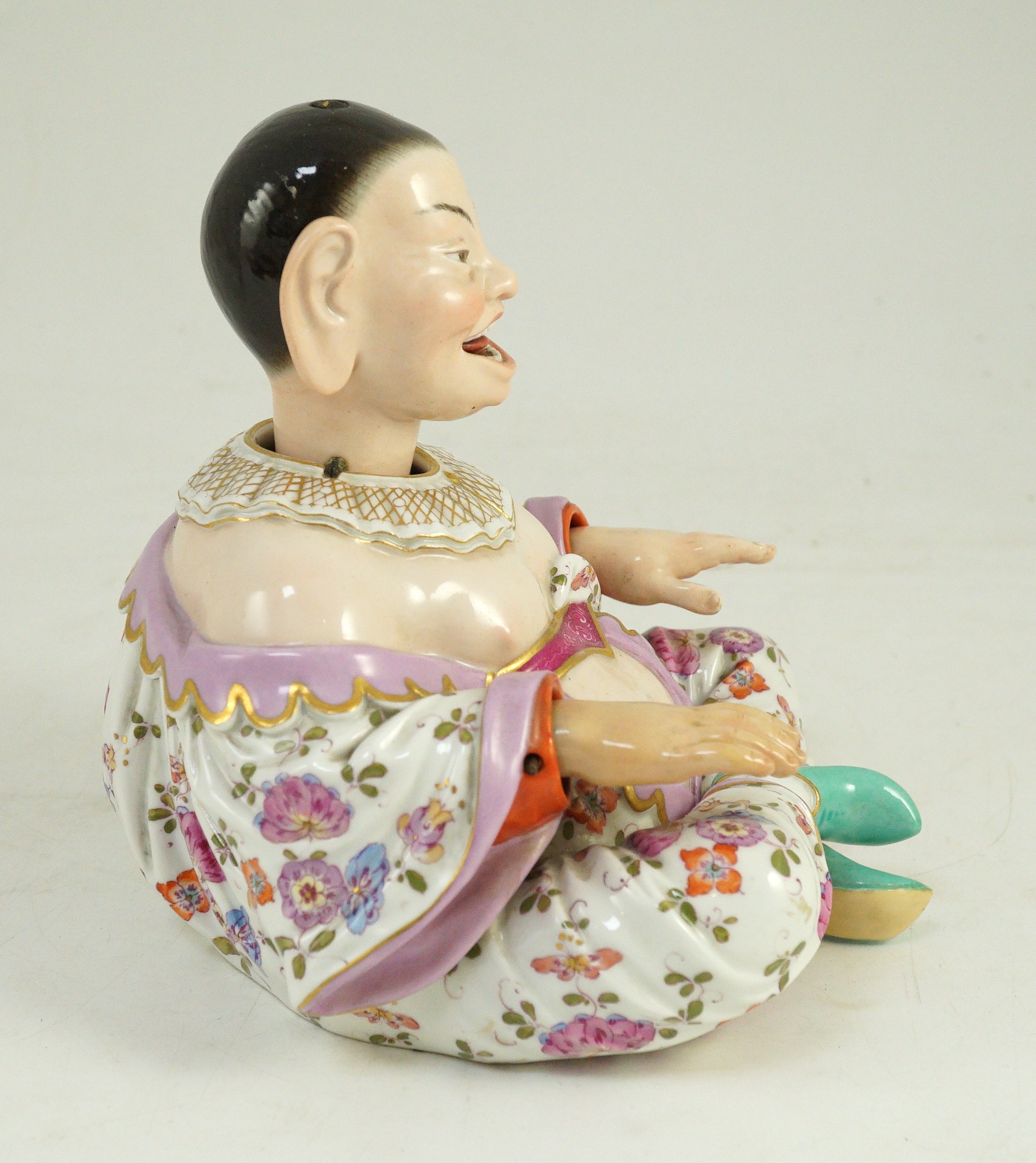 A Meissen figure of a nodding chinaman, 19th century, 17.5cm high, right hand restored